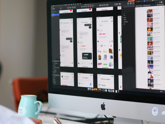Computer showing new website design artboards